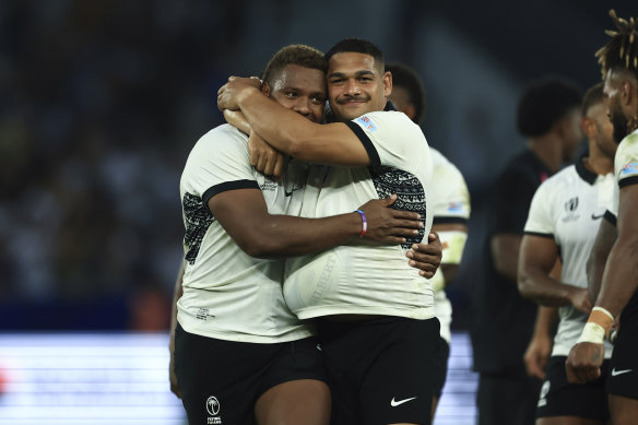 Fiji’s Ilaisa Droasese and Samuel Matavesi embrace after defeating the Wallabies.