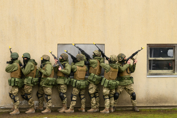 Ukrainian volunteers run through urban warfare training with members of the British Armed Forces at a military camp in South East England. 