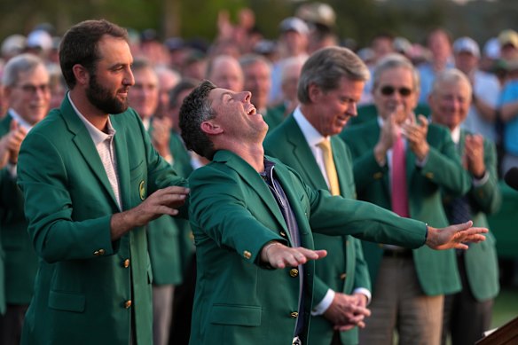 Scottie Scheffler puts the green Jacket on winner, Rory McIlroy. 