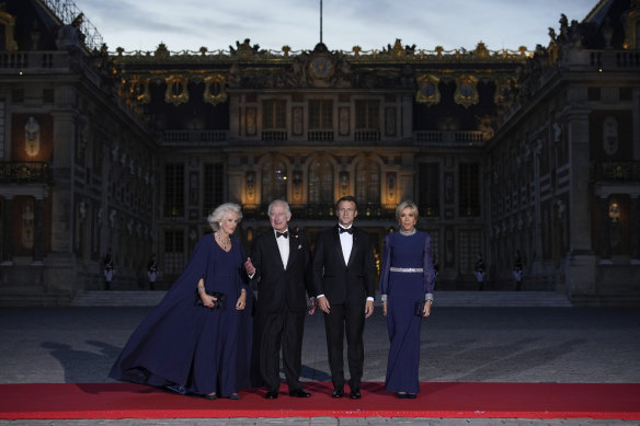 Queen Camilla, King Charles, French President Emmanuel Macron and his wife Brigitte on the red carpet at Versailles.