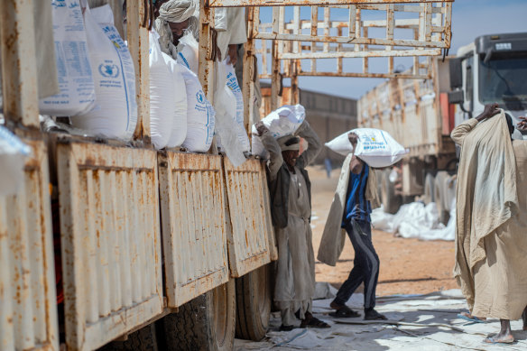 Workers move wheat arriving from Ukraine in Port Sudan, Sudan.