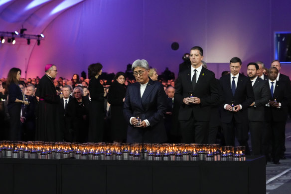 Australian Foreign Minister Penny Wong places a candle at the Auschwitz-Birkenau former Nazi death camp. 