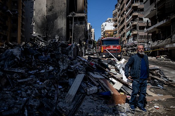 A man stands amid the rubble of a building destroyed in an Israeli airstrike in Beirut.