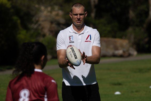 Tom Trbojevic puts kids through their paces at an Ampol Little Origin clinic.