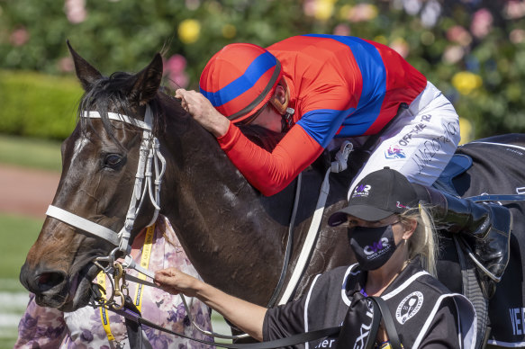 James McDonald gives Verry Elleegant a hug after her Melbourne Cup win.