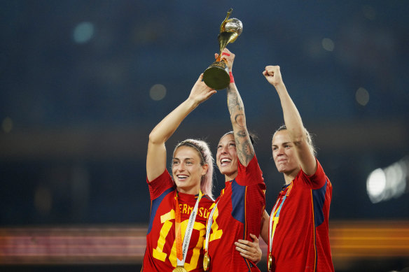 Spain’s Alexia Putellas, Jennifer Hermoso and Irene Paredes, from left, celebrate with the trophy at the end of the Women’s World Cup final.