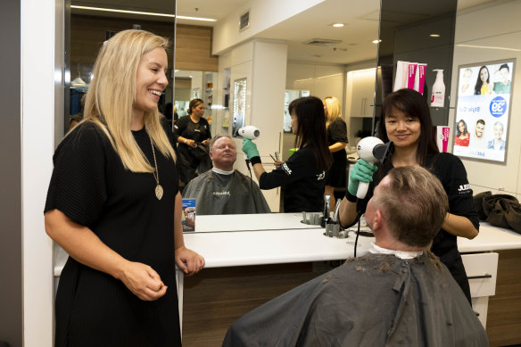 JustCuts CEO Amber Manning watches as regular customer Robert Elder gets a haircut in Randwick, Sydney.