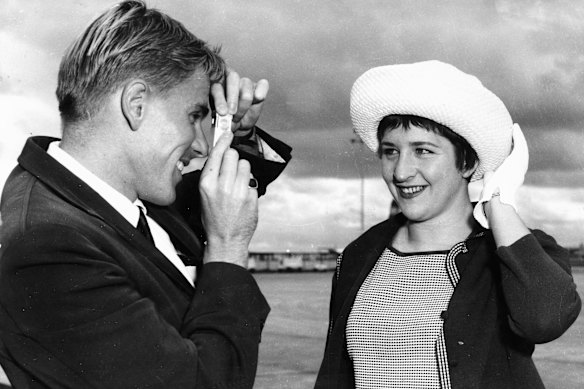 Australian swimmers Murray Rose and Dawn Fraser, both world record holders, gather with the team prior to their departure to Perth for the 1962 Commonwealth Games.