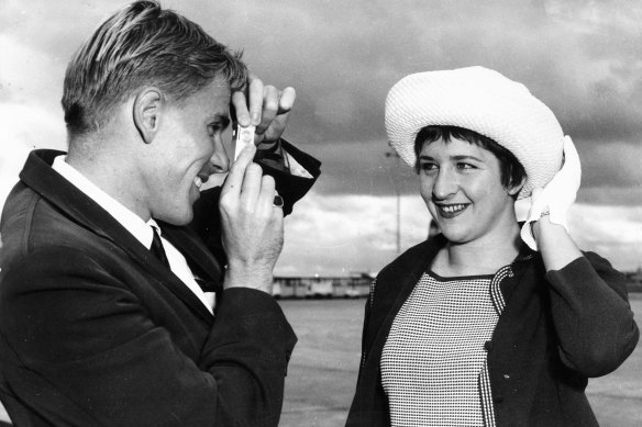 Australian swimmers Murray Rose and Dawn Fraser, both world record holders, gather with the team prior to their departure to Perth for the 1962 Commonwealth Games.