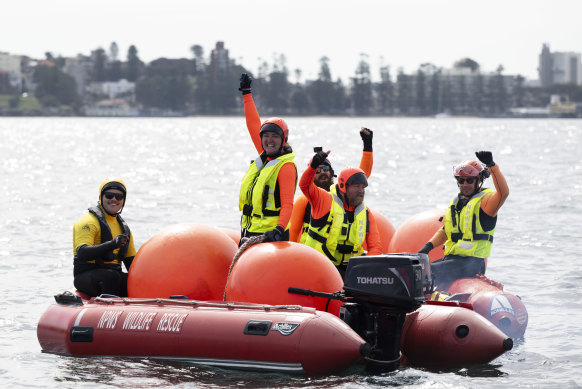 Rescuers celebrate after the whale they had just freed turned and swam for the open sea.