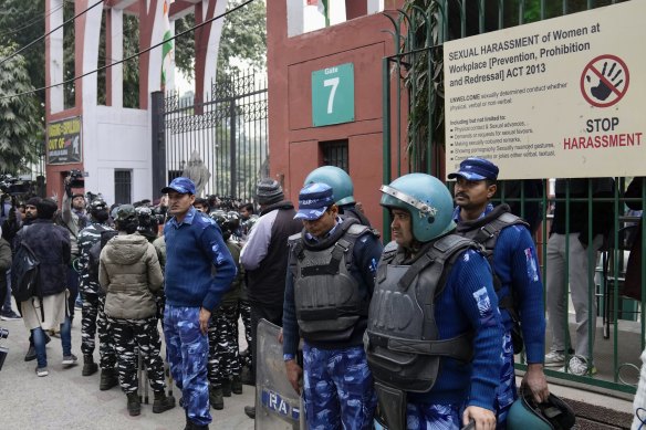 Security personnel guard the main gate of Jamia Millia Islamia university to prevent a planned protest being held against alleged detention of student leaders for organising a screening of the Modi documentary.