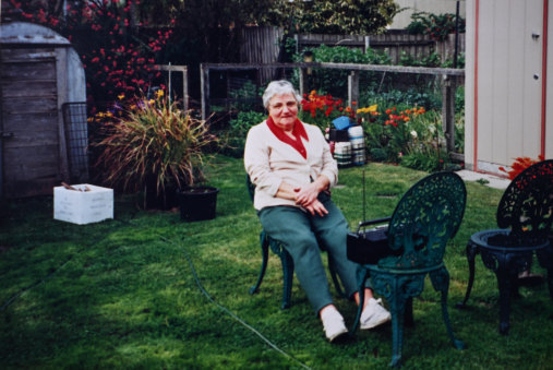 Rodney Binns’ mother Madeline Binns in  front of the air raid shelter in the 1980s.