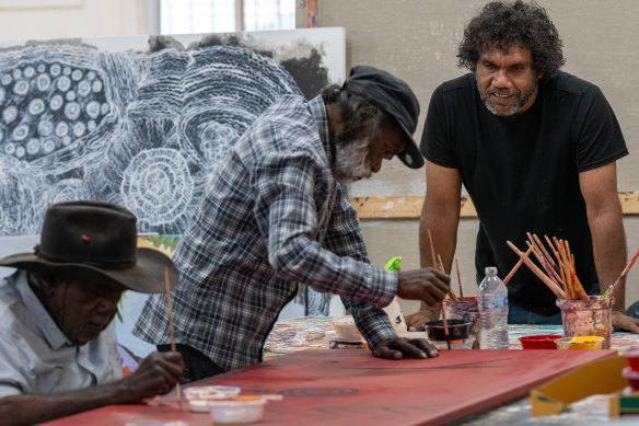 Namatjira (right) mentoring artists Alec Baker and Eric Barney for the NGV’s <i>My Country</i> exhibition.