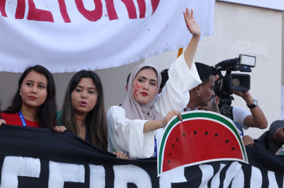 A woman holding a watermelon sign at a protest in Dubai in early December.