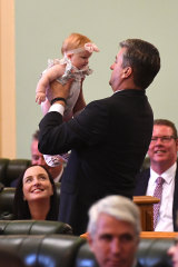 Logan MP Linus Power holds Brittany Lauga's baby Odette in Parliament on Tuesday.