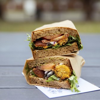Falafel and pesto sandwich, piled on rich brown bread.