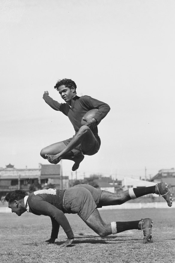 Player Mervyn William's brother Mick, 18, shows at practice the way he leaps over a tackling player. One of the images found in the lost archive. 
