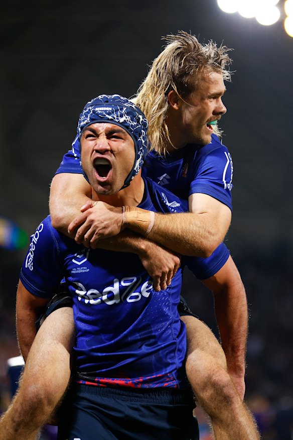 Jahrome Hughes and Ryan Papenhuyzen celebrate on the field.
