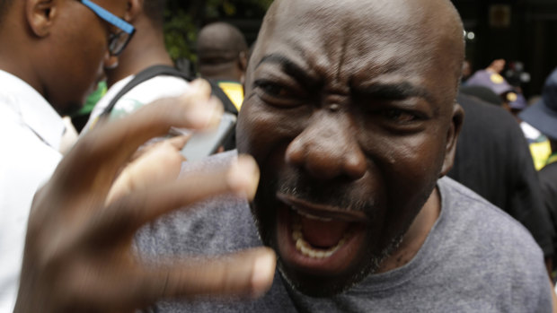 A member of the African National Congress  protesting against President Jacob Zuma outside the party's headquarters in downtown Johannesburg on Monday.
