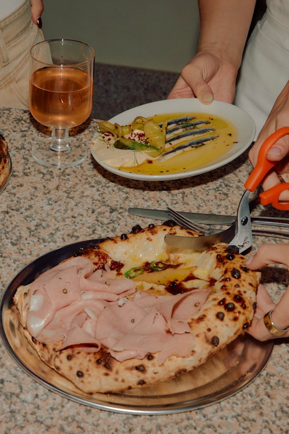 Cut your pizza at the table with the provided scissors.