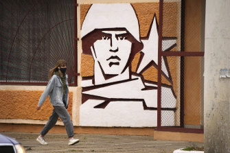 A woman walks past the Operational Group of Russian Forces headquarters in Tiraspol, the capital of the breakaway region of Transnistria, a disputed territory unrecognised by the international community, in Moldova.