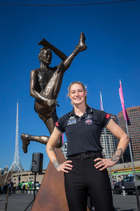 Tayla Harris unveils a prototype of her upcoming bronze statue at Federation Square in 2019.