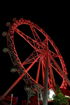 The Melbourne Star observation wheel in Docklands, lit up earlier this month for Remembrance Day. Its operators have halved their staff since last summer.