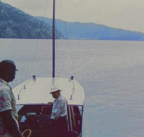 Bev Todd and boatman Willy at Monos Island in March 1956.