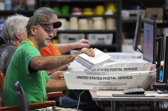 Allegheny County workers scan mail-in and absentee ballots at the Allegheny County Election Division Elections warehouse in Pittsburgh, Thursday. 