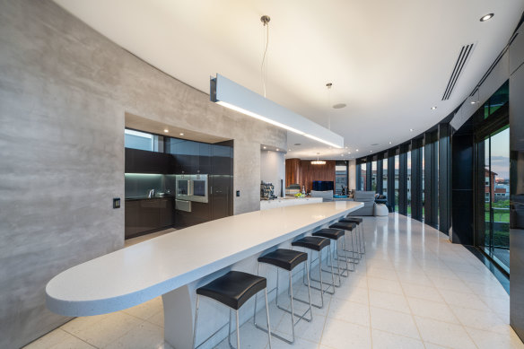 Curved walls, floor-to-ceiling windows and a kitchen with butler’s pantry.