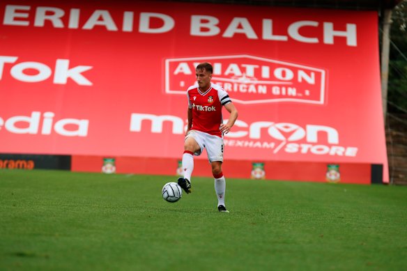 Wrexham FC captain Luke Young runs with the ball. 