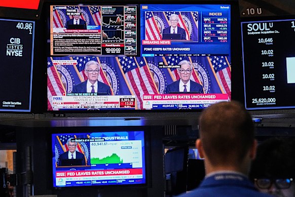 Screens on a trading post on the floor of the New York Stock Exchange show the news conference of Federal Reserve Chair Jerome Powell.