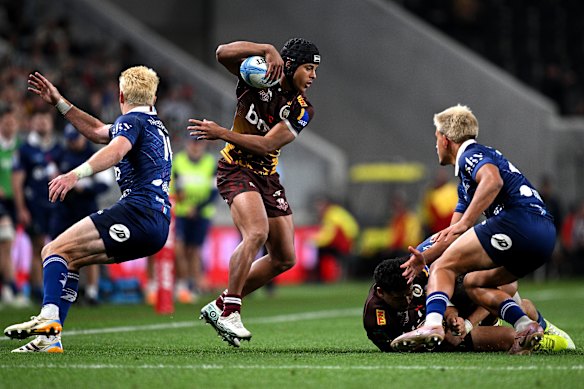 Treyvon Pritchard of the Reds fends off the defence.