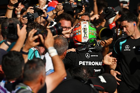 Mercedes workers rush to embrace, who  has taken a dominant lead in the championship. 