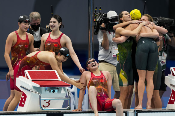 Chinese swimmers celebrate their surprise win as Australia is relegated to third in the women’s 4x200m relay final.