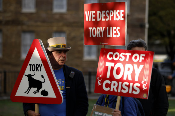 Demonstrators protest opposite parliament after Britain’s Prime Minister Liz Truss resigned.