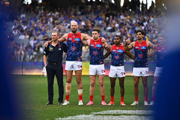 Arm in arm: Demons coach Simon Goodwin, skipper Max Gawn and the Demons, who have had a difficult season.