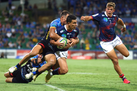 Matt To’omua is tackled by Richard Kahui in the Rebels’ win over the Force in March 2021.