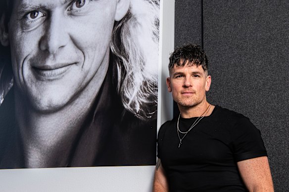 Michael Paynter with a poster of John Farnham, after the Whispering Jack announcement in January.