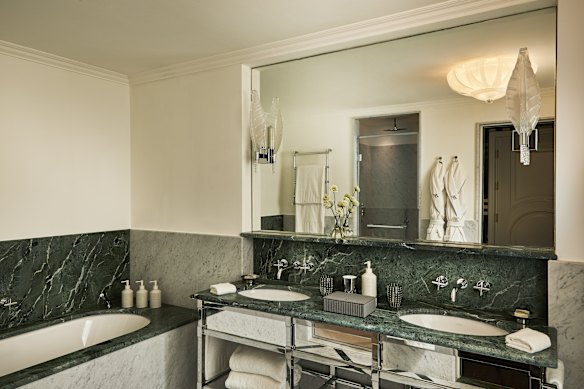 Plenty of green Carrara marble in the bathroom.