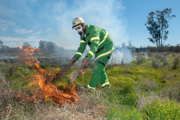 Mick Bourke lights a fire using traditional methods in Boort, Victoria, in September 2019.