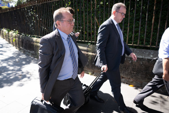 Gordon McAndrew (left) leaves court during his trial at Darlinghurst.