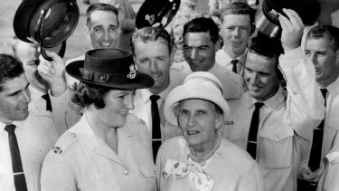 Lillian Armfield, aged 80,  with a group of constables who were sworn in at the passing-out parade in Redfern, in 1964.