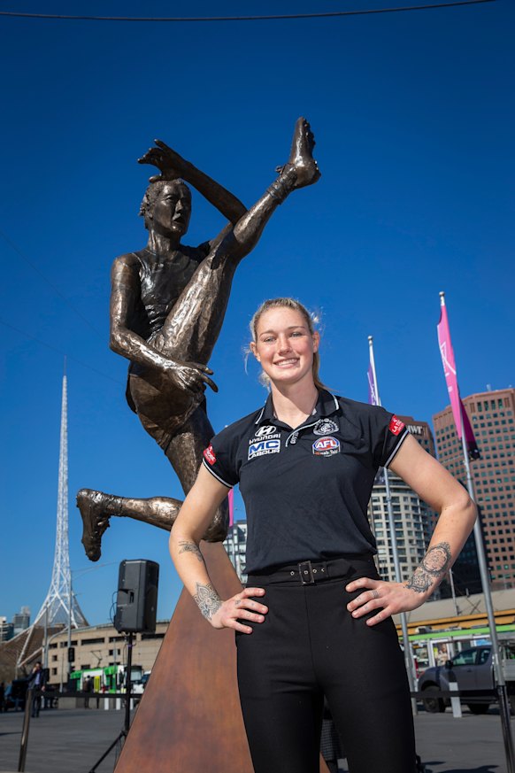Tayla Harris unveils a prototype of her upcoming bronze statue at Federation Square in 2019.