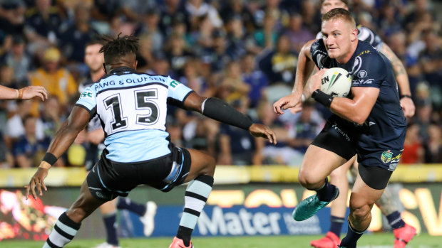 Poor start: James Segeyaro attempts to tackle Coen Hess in the Sharks' round one loss to North Queensland.