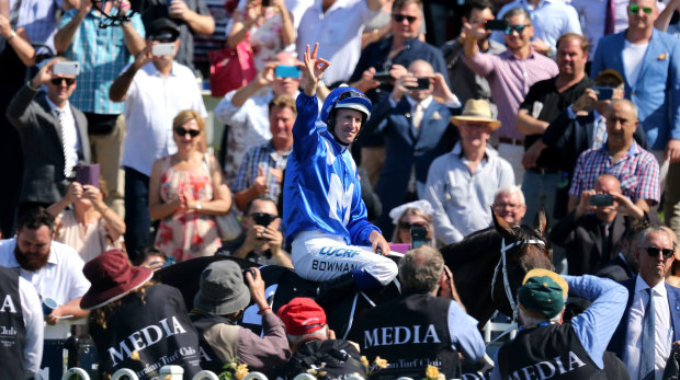 Triumphant: Hugh Bowman gestures to the crowd after another winning run at Rosehill.