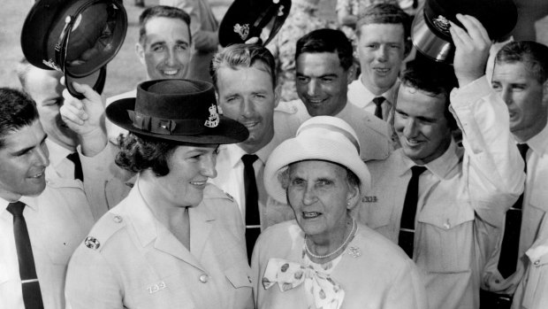 Lillian Armfield, aged 80,  with a group of constables who were sworn in at the passing-out parade in Redfern, in 1964.