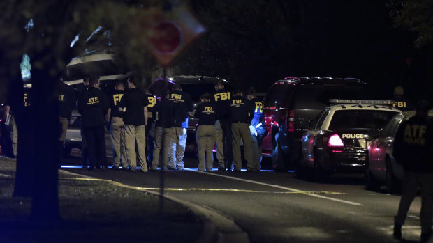 Officials investigate near the area of the latest explosion in Austin, Texas. 