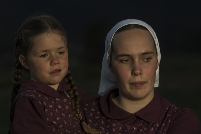 Esther, 17, holds her sister Ruth, 4.