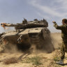 An Israeli soldier directs a tank near the border with the southern part of the Gaza Strip.